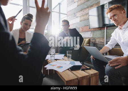 Group of young business people in a meeting at office. Discussing new business ideas. Stock Photo