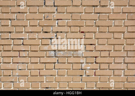 Beige weathered bricks wall in sunlight, texture background Stock Photo