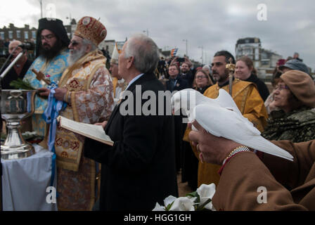 White Dove a traditional symbol of Love and Peace. The Greek community in Margate Kent celebrate the Epiphany 6th January with the Blessing the Sea ceremony.  The dove shortly before being released. A Christian festival - feast day, commemorating the visit of the Magi and the baptism of Jesus. England 2017 2010s UK HOMER SYKES Stock Photo