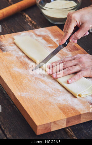 Making handmade pasta on wooden table Stock Photo