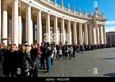 Tourists stand in line to get into the Basilica in St. Peter's square. Rome, Italy, Europe, EU, European Union. UNESCO world heritage site