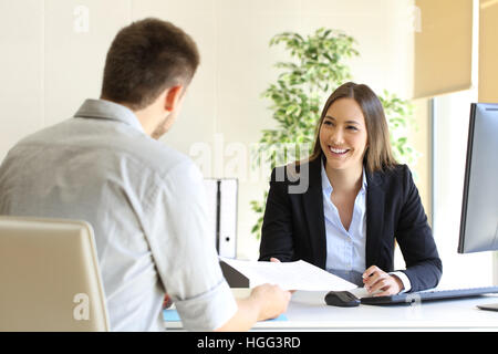 Guy giving a curriculum vitae to his interviewer in a job interview Stock Photo