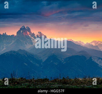Dramatic morning view of mountain Ushba. Colorful autumn sunrise in the Caucasus mountains, Upper Svaneti, Georgia, Europe.  Artistic style post proce