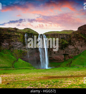 Morning view of Seljalandfoss Waterfall on Seljalandsa river in summer. Colorful sunrise in Iceland, Europe. Stock Photo