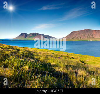Typical Icelandic landscape with volcanic mountains and pure water river. Sunny summer morning in the west coast of Iceland. Stock Photo