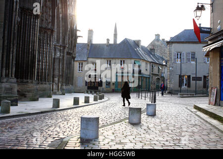 A female walking towards the entrance to Notre Dame Cathedral in Bayeux, Normandy, France. Stock Photo