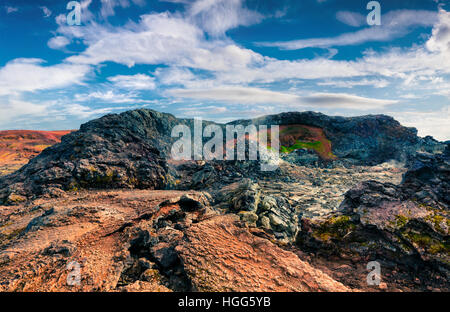 Fields of steamy waters in the Krafla volcano. Colorful exotic landscape with lava ground in the geothermal valley Leirhnjukur. Stock Photo