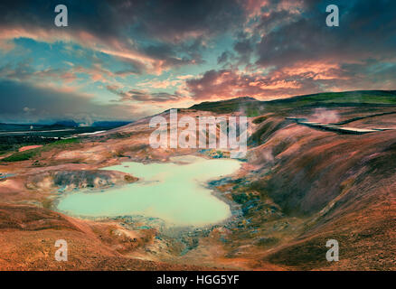 Boiling water lake in the Krafla volcano. Colorful exotic sunset with lava ground in the geothermal valley Leirhnjukur. Stock Photo