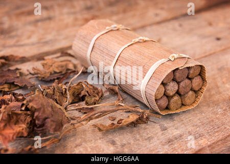Close up of a cuban handmade box of cigars, with dried tobacco leaves Stock Photo