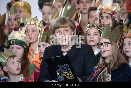 Berlin, Germany. 9th Jan, 2017. German Federal Chancellor Angela Merkel receives songs from carol singers from all over Germany in Berlin, Germany, 9 January 2017. Carol singers from all 27 dioceses in the country visit the chancellery for epiphany, as custom determines. Photo: Michael Kappeler/dpa/Alamy Live News Stock Photo