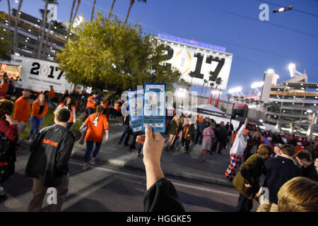 Tampa, USA. 9th Jan, 2017. Jody Gallagher, of Greenville, South Carolina, holds up two tickets that he was selling outside of Raymond James Stadium for the College Football Playoff National Championship game between the Alabama Crimson Tide and the Clemson Tigers in Tampa. Credit: ZUMA Press Inc/Alamy Live NewsTampa, USA. 9th Jan, 2017. Credit: ZUMA Press Inc/Alamy Live News Stock Photo