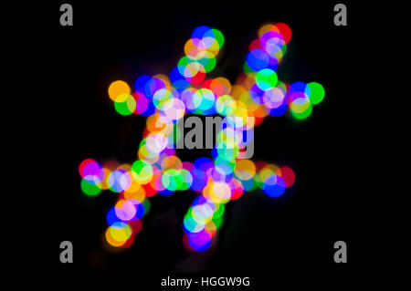 Hashtag made from bright colorful bokeh light bubbles as a symbol of mindfulness from technology glowing against a dark background Stock Photo