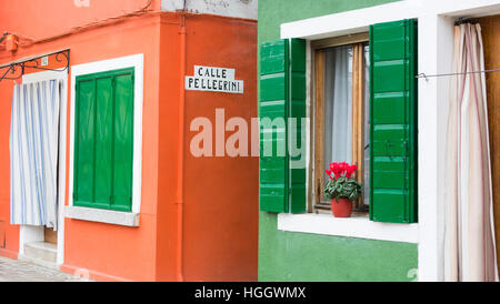 Green and orange houses on Burano, Venice, Italy Stock Photo