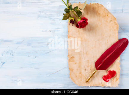 Ancient paper, roses, pen and hearts. Stock Photo