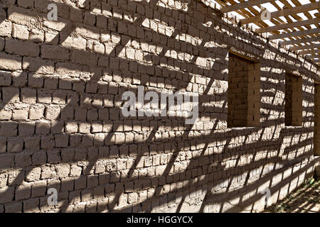 Shadows on a mud brick wall. Stock Photo