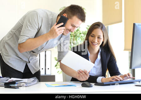 Business team coworking with multiple devices and a desktop computer at office Stock Photo