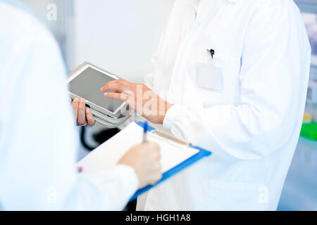 Young researcher using tablet PC Stock Photo