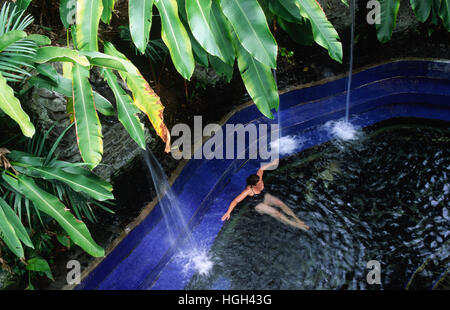 A woman is relaxing in a Thermal bath close to the volcano Arenal, La Fortuna, Costa Rica, Central America