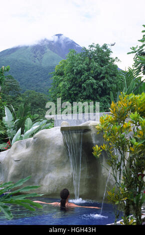 A woman is relaxing in a Thermal bath close to the volcano Arenal, La Fortuna, Costa Rica, Central America