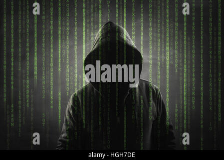 hacker over a screen with binary code Stock Photo