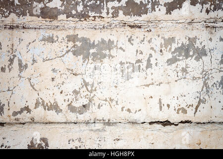 Concrete block wall background. Peeling white paint on concrete texture