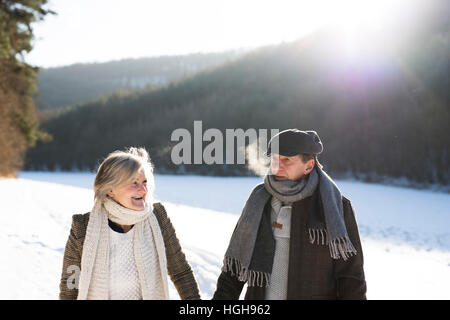 Beautiful senior couple on a walk on sunny winter day