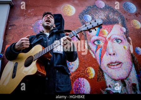 David Bowie Musical Walking Tour of Brixton on 08/01/2017 at Brixton Academy, . Pictured: The final stop was the Bowie Mural (Memorial). With the many other fans gathered to mark their hero's birthday, there was a mass singalong to 'Heros' . Stock Photo