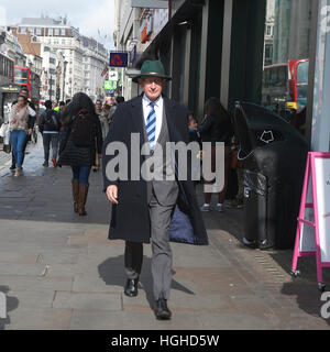 LONDON - October 27, 2016: Old man in the green hat gentleman walking down the street Stock Photo