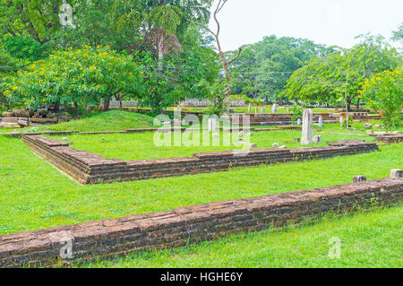 The brick foundation and ruins of stone pillars of the ancient buildings in Jetavana Vihara complex, Anuradhapura, Sri Lanka. Stock Photo
