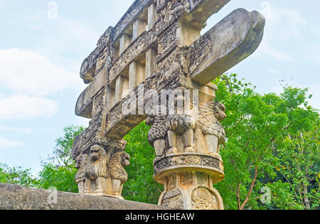 The Torana Gate of Mihintale replica of Great Sanchi Stupa decorated with lions, sitting under the beams of gateway and holding them, Sri Lanka. Stock Photo