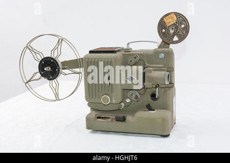 old film projector. projects, one frame imprinted on film, and through a lens focuses the resulting image on a screen. Stock Photo