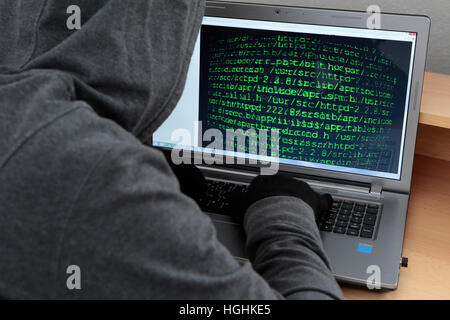 Unrecognizable hacker in front of computer – cybercrime concept Stock Photo