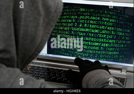 Unrecognizable hacker in front of computer – cybercrime concept Stock Photo