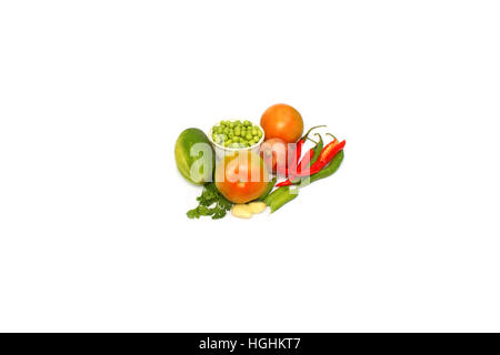 A selection of natural vegetable arranged in and around a Coriander leaves, chilli,beens,onion,garlic,tomato. Stock Photo