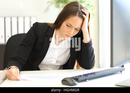 Depressed and ruined businesswoman looking at negative growing graphic after bankruptcy Stock Photo