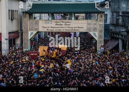 Manila, Philippines. 9th Jan, 2017. The carriage of the Black Nazarene as it makes its way through the welcome arch of the Muslim Town in Quiapo, Manila. Millions of barefoot Catholic devotees participate on the annual Black Nazarene Traslacion in Manila. Many Black Nazarene devotees believe that by pulling the carriage rope of the statue willl help in the antonement of their sins. © J Gerard Seguia/Pacific Press/Alamy Live News Stock Photo