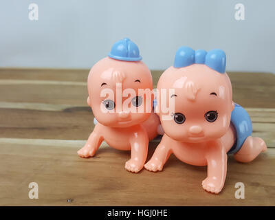 Mechanical wind up crawling baby toy on wood background Stock Photo