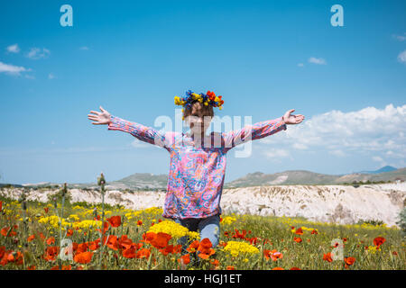 Happy girl in poppy field with phone Stock Photo - Alamy
