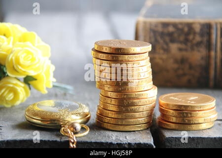 Stacks of golden coins on wooden table. Business or finance concept. Stock Photo