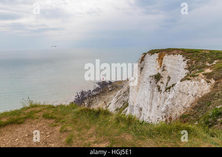 Shot of the lighthoue which is out to sea off the cliffs of Beachy Head.  The tide is out and its a cloudy day. Stock Photo