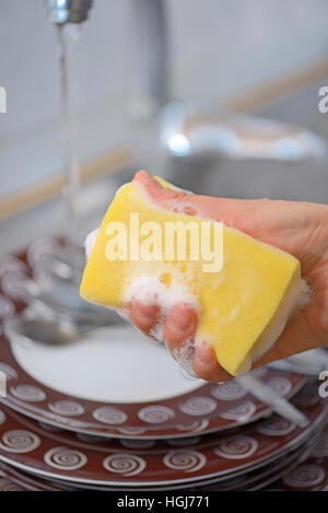 Washing the dishes on the kitchen sink Stock Photo