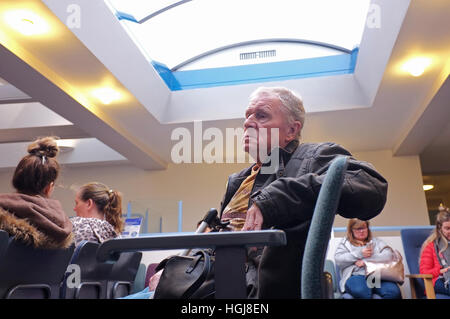 An elderly man sitting in the waiting room of a Doctors surgery in Cornwall Stock Photo