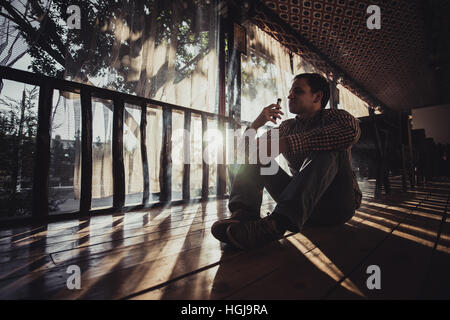 Young Man Using Vapourizer As Smoking Alternative Stock Photo