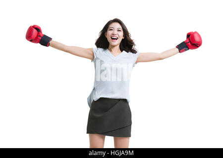 Happy young woman wearing boxing gloves Stock Photo