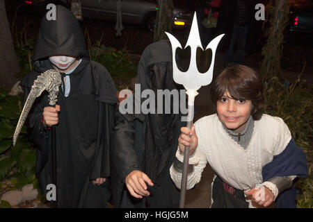 Halloween Grim Reaper death Neptune or Poseidon with a trident costumes out for trick or treat.  St Paul Minnesota MN USA Stock Photo