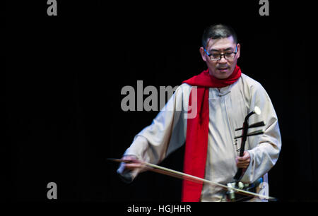 New York, USA. 9th Jan, 2017. Musician of China's Inner Mongolia National Arts Theater Wu Haibin performs Erhu solo 'Horse Race' during the 2017 'Embrace China-New York' grand performances gala in New York City, the United States, on Jan. 9, 2017. The gala, jointly hosted by All-China Federation of Returned Overseas Chinese (AFROC) and Consulate General of China in New York, provided an opportunity for overseas Chinese and Americans to enjoy contemporary Chinese cultural performances and celebrate the upcoming Chinese lunar New Year. © Li Rui/Xinhua/Alamy Live News Stock Photo