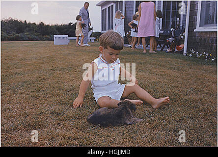 Hyannisport, MA, Squaw Island -- John F. Kennedy Jr. with puppy on in Hyannisport, Massachusetts on August 3, 1963. Mandatory Credit: Cecil Stoughton - The White House via CNP - NO WIRE SERVICE - Photo: Cecil Stoughton/Consolidated News Photos/White House via CNP Stock Photo