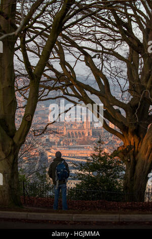 Bath, UK. 22nd January 2017. The famous Abbey and Georgian architecture are bathed in a warm glow as cold weather and clear skies continue across the South West. A person stands and admires the view from Alexandra Park in the south of the city. © Wayne Farrell/Alamy Live News Stock Photo