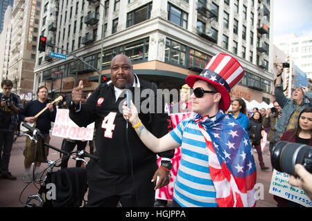 Los Angeles, California, USA. 21st January, 2017. A man called 'Big Joe' is interviewed by Jeffrey Mark Klein, and speaks in favor of newly elected President Donald Trump of the United States amidst the anti-Trump protesters around him at The Women's March in Los Angeles, California, USA, on January 21st, 2017.  'Big Joe' said that he was just passing through the area when he saw the protest, and called for unity and support for President Trump.  Credit: Sheri Determan/Alamy Live News Stock Photo