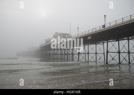 Worthing Pier on a foggy day during low tide in Worthing, West Sussex, England. Stock Photo